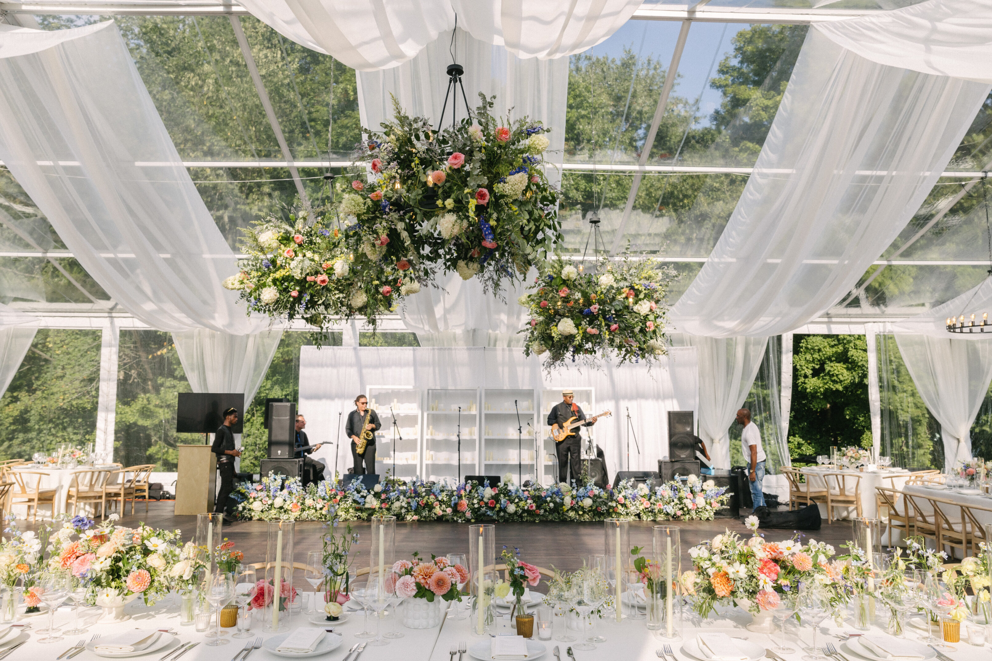 Elegant tented reception with summer florals. Tent Rental from Greenwich Tent Company for private event in Fairfield, CT. Clearspan Structure Tent for outdoor events.