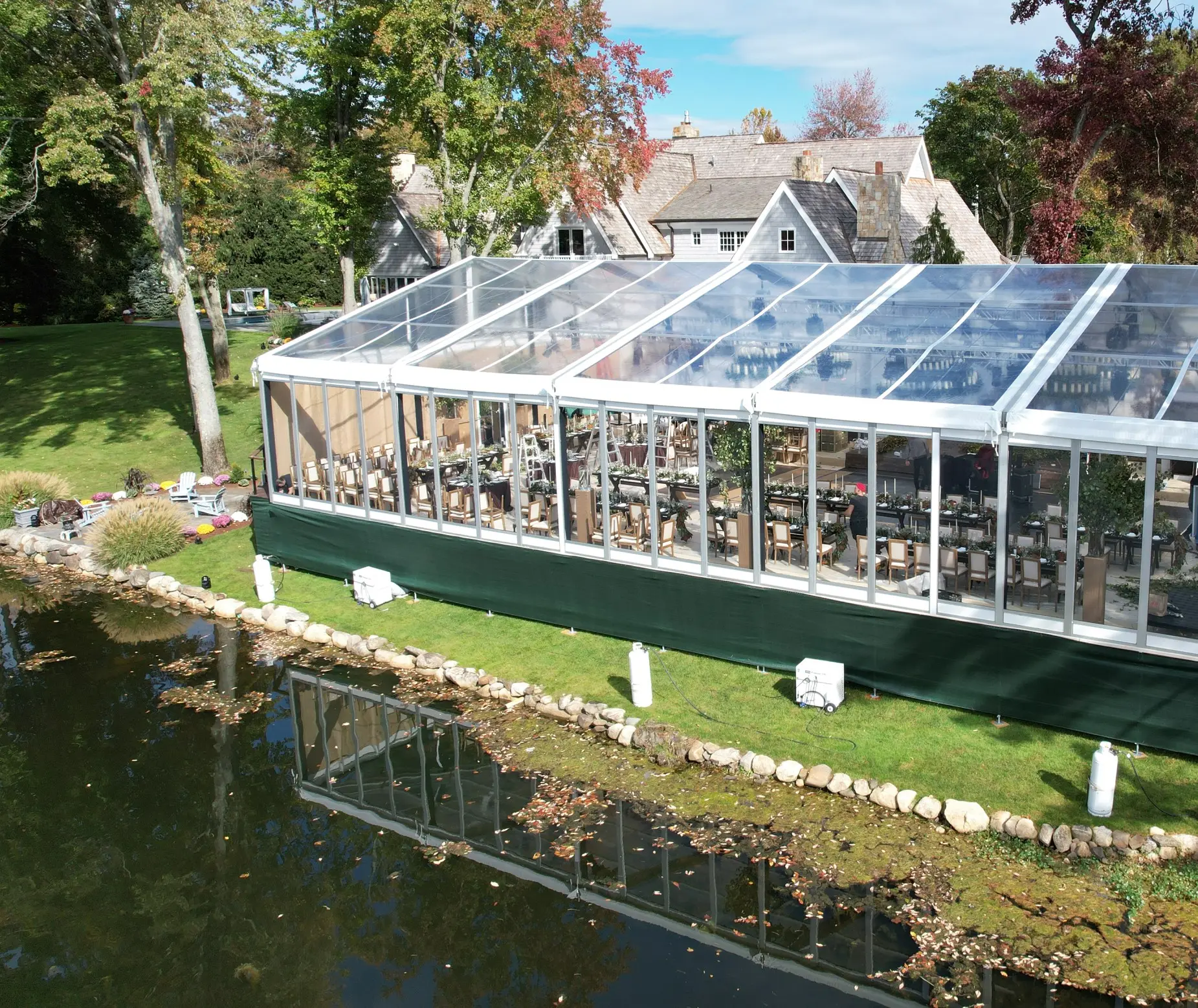 Daytime exterior clear span clear top Losberger structure with raised flooring