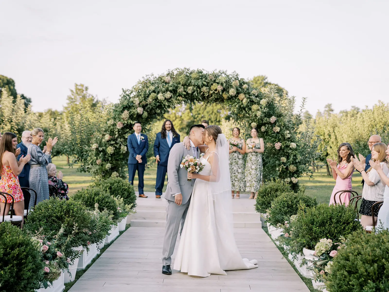 This romantic apple orchard wedding featured a stunning sailcloth tent provided by Greenwich Tent Company.
Sailcloth wedding tent in apple orchard.