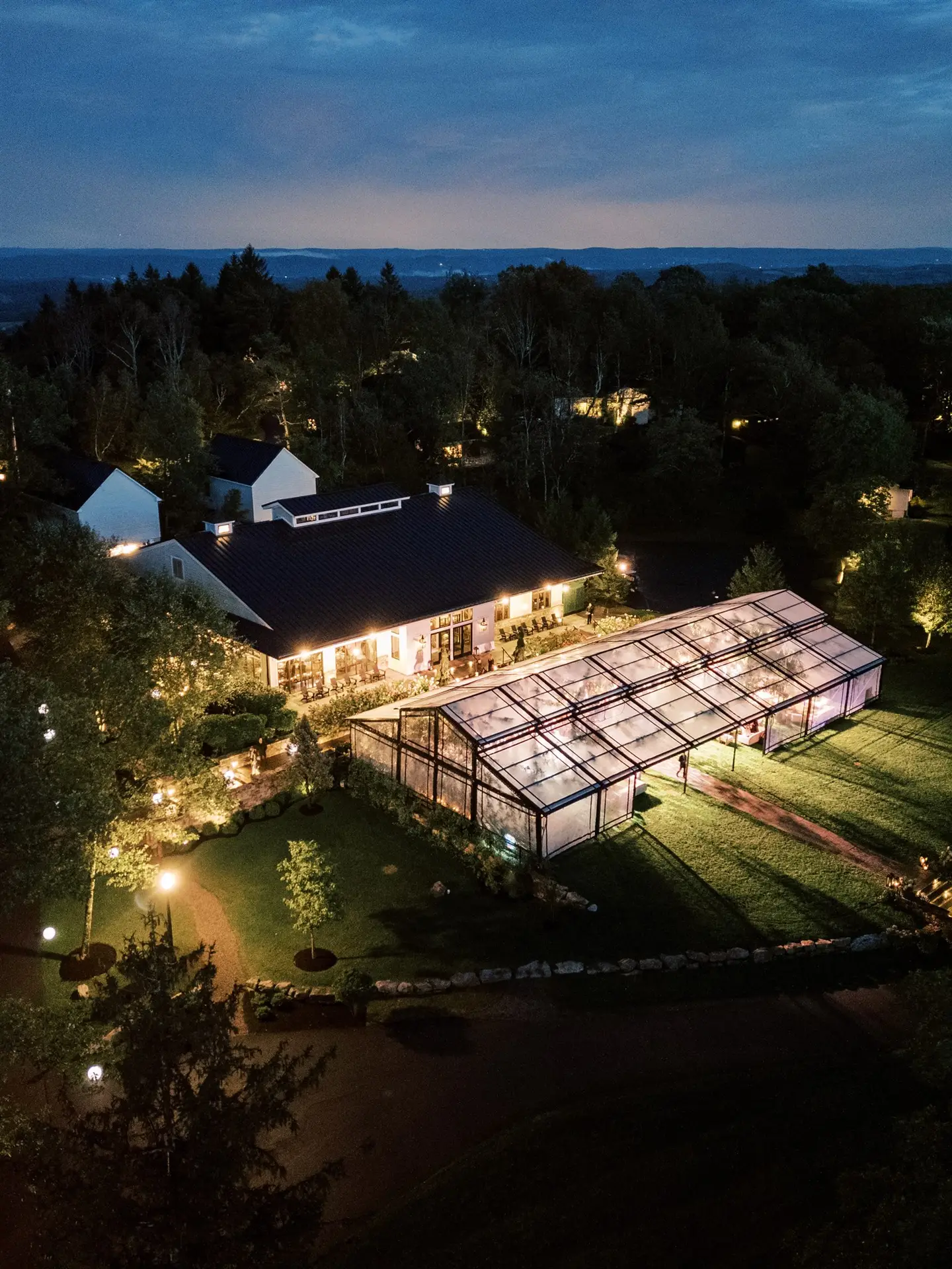 Nighttime exterior aerial of the black powder coated garden structure