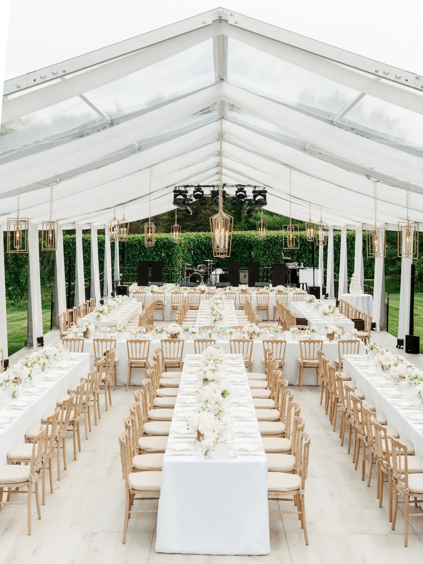 Daytime interior clear span clear top Losberger structure with banquet tables with full floor