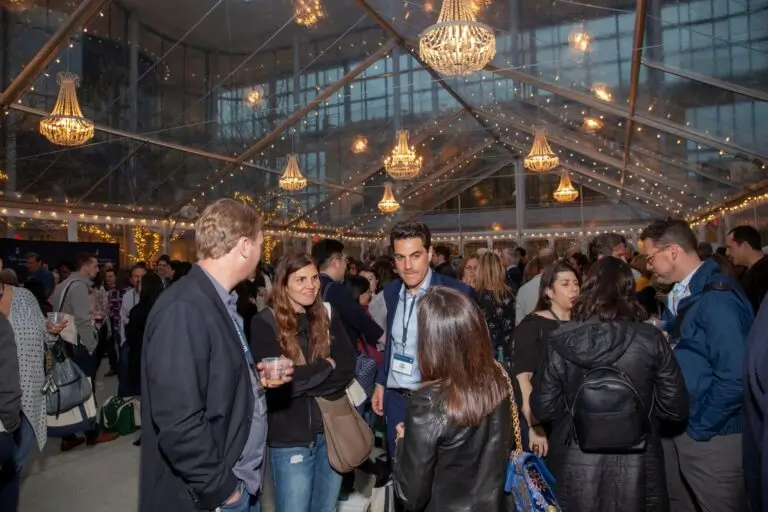 Crowded event under elegant lighting.
