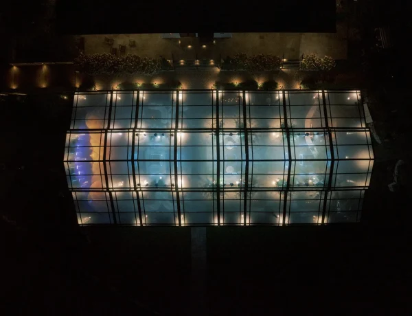 Nighttime exterior aerial of the black powder coated garden structure