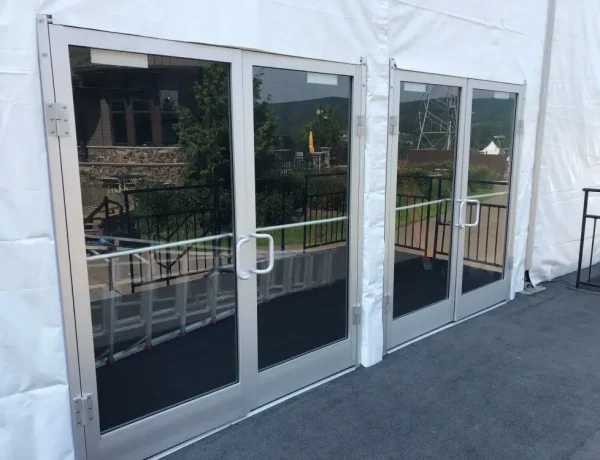 Outdoor structure tent rental with glass doors and walls for corporate outdoor event