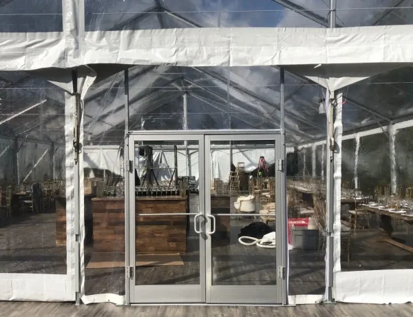Structure tent glass doors and sides for outdoor event for a corporate party from Greenwich Tent