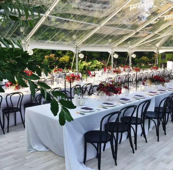 Interior day time clear span clear top Losberger structure banquet tables and full floor with cooling