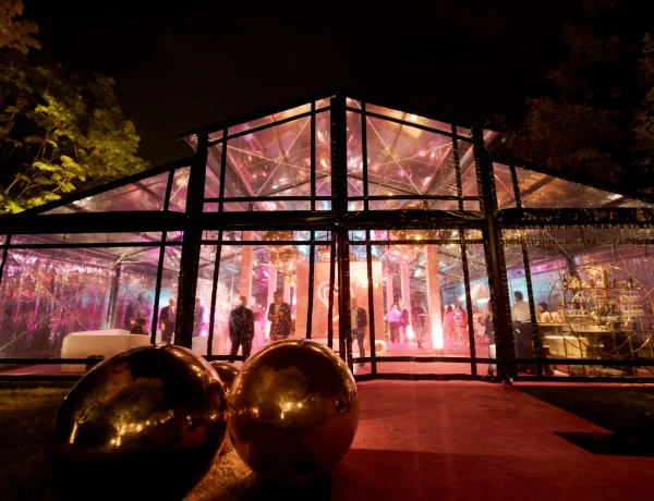 Nighttime exterior of the black powder coated garden structure with decor