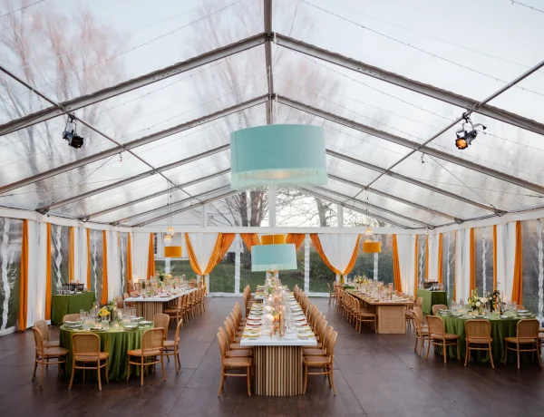 Daytime interior clear span clear top Losberger structure with banquet tables