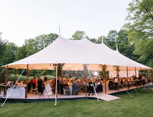 Daytime exterior of Sperry sailcloth tent, full floor, floral decor