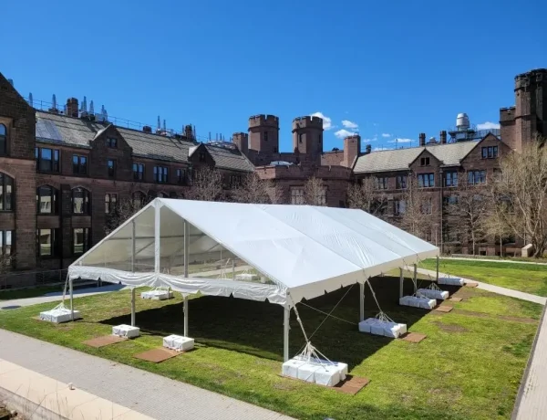 Daytime exterior frame tent with white tops and clear gable ends