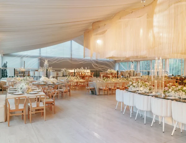 Daytime interior clearspan clear top Losberger structure with full floor and fabric tassels hung from rafters