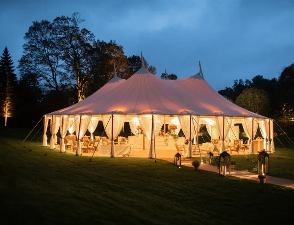 Nighttime exterior of Sperry sailcloth tent, full floor, floral decor